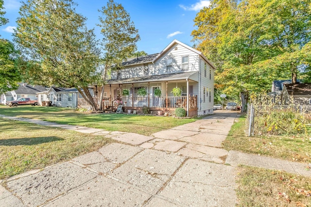 view of front facade with covered porch and a front yard