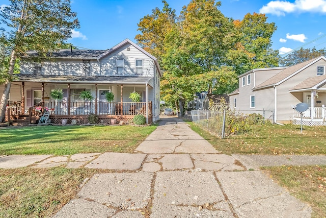 view of front of home featuring covered porch and a front yard