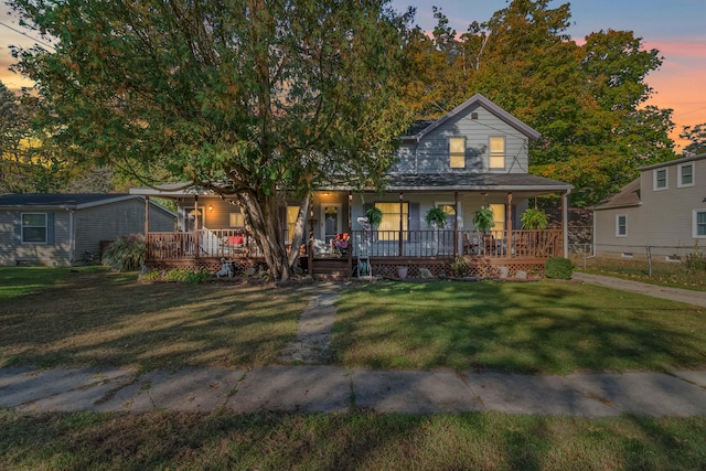 view of front of house featuring covered porch and a lawn