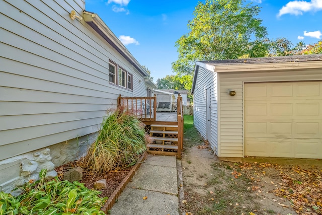 view of side of home featuring an outbuilding and a garage