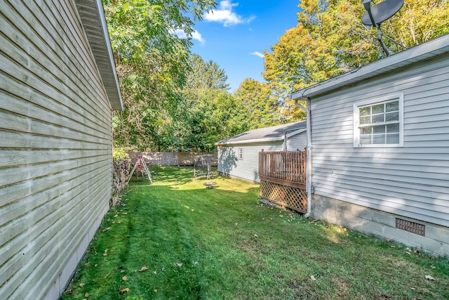 view of yard featuring a wooden deck