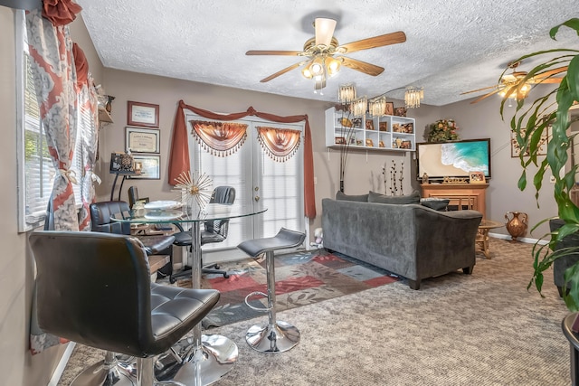 carpeted living room with french doors, a textured ceiling, and ceiling fan