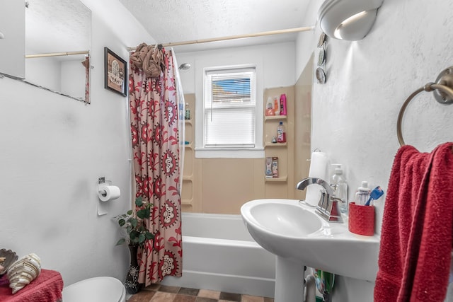 full bathroom with sink, shower / bath combination with curtain, a textured ceiling, and toilet