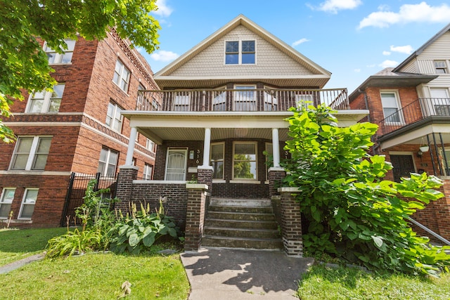 view of front of property featuring a porch and a balcony