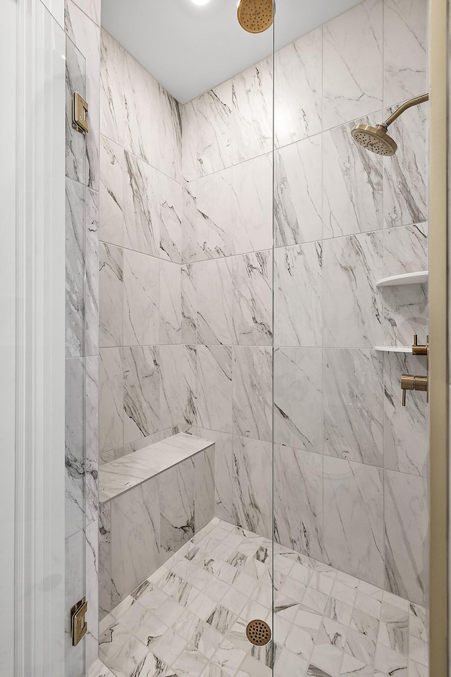 bathroom with tiled shower