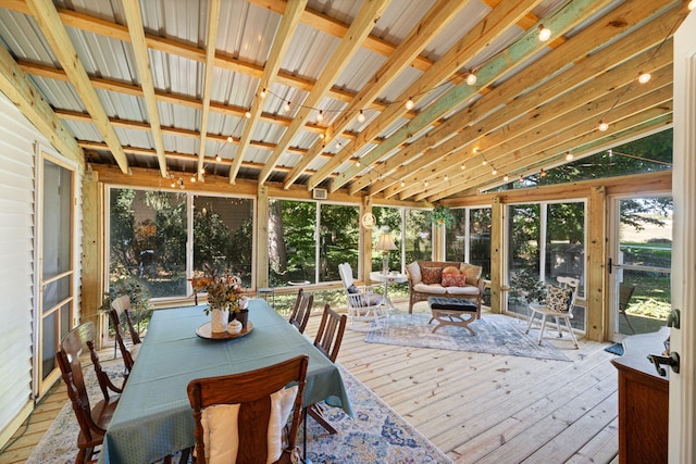 sunroom / solarium featuring vaulted ceiling