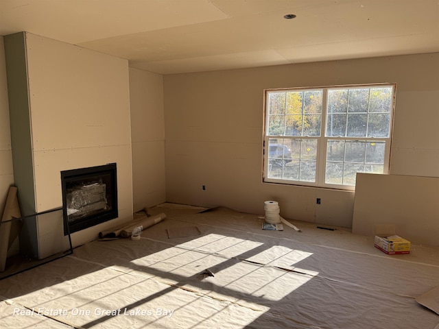 7585 S Steel Rd, Saint Charles, MI 48655 - unfurnished living room featuring a fireplace
