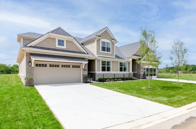 view of front of property with a front yard and a garage