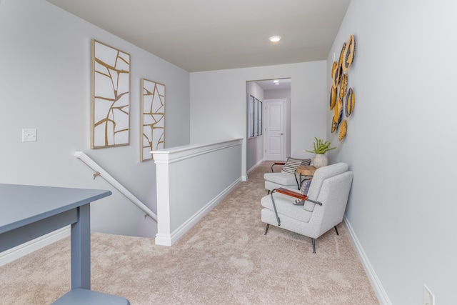 hallway with light colored carpet