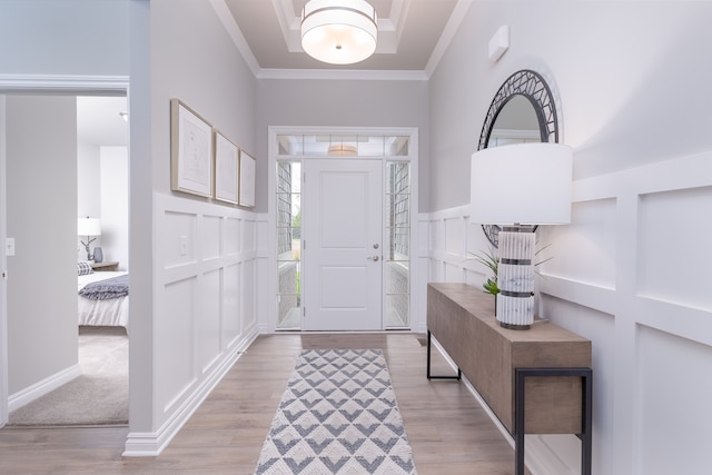 entrance foyer featuring light hardwood / wood-style flooring and ornamental molding