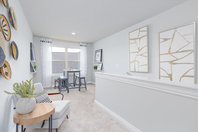 sitting room featuring light carpet