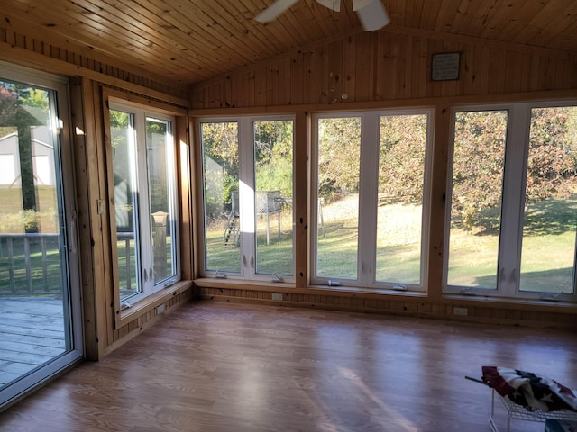 unfurnished sunroom featuring a wealth of natural light and vaulted ceiling