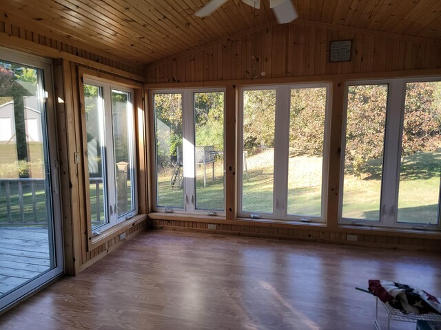 4085 N Cedar Lake Rd, Edmore, MI 48829 - unfurnished sunroom featuring lofted ceiling, wood walls, and wood finished floors