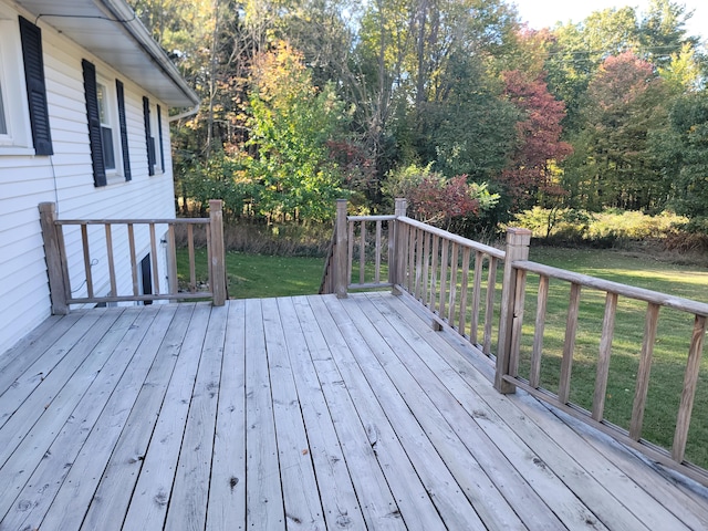 wooden deck with a lawn