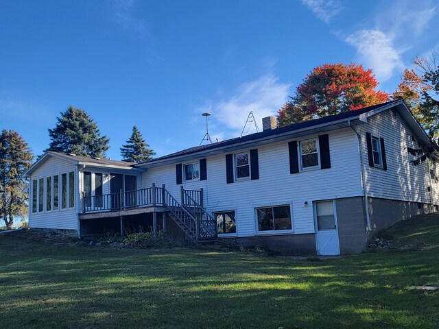 4085 N Cedar Lake Rd, Edmore, MI 48829 - rear view of house featuring a yard, a chimney, a sunroom, and stairway