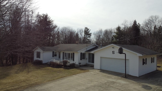 ranch-style house featuring driveway, a front yard, and a garage