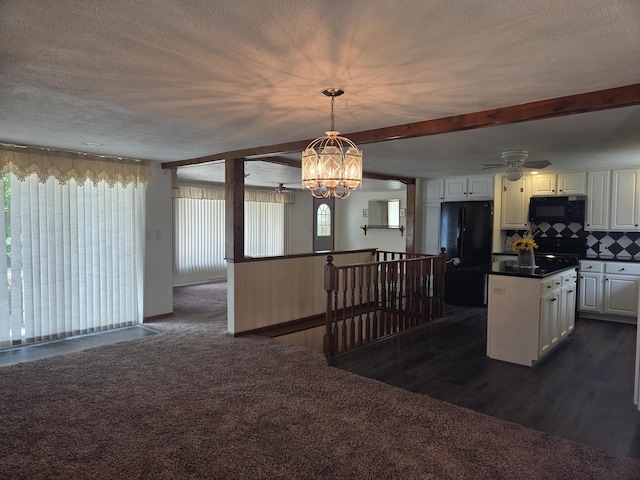 4085 N Cedar Lake Rd, Edmore, MI 48829 - kitchen featuring black appliances, white cabinetry, a textured ceiling, dark countertops, and decorative backsplash
