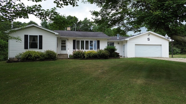 4085 N Cedar Lake Rd, Edmore, MI 48829 - ranch-style home with an attached garage, a chimney, a front yard, and driveway
