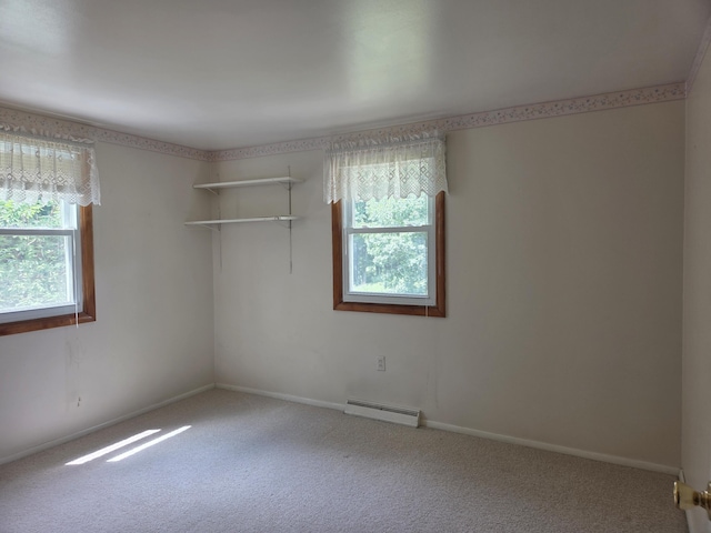 4085 N Cedar Lake Rd, Edmore, MI 48829 - spare room with a baseboard heating unit and carpet floors