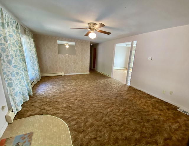 carpeted spare room featuring baseboard heating and ceiling fan