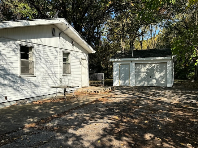 view of side of home with a garage and an outdoor structure