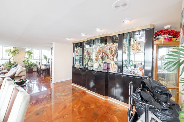 interior space featuring concrete flooring and bar area