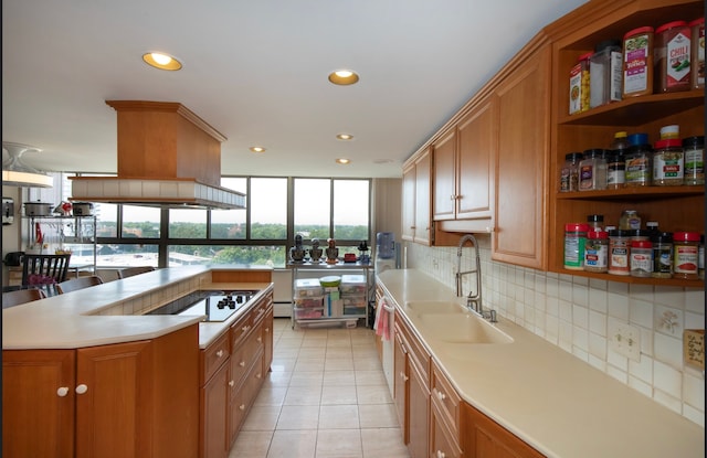 kitchen featuring light tile patterned floors, electric cooktop, plenty of natural light, and sink