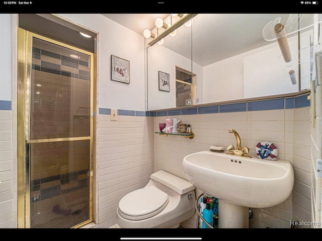 bathroom with an enclosed shower, toilet, and tile walls