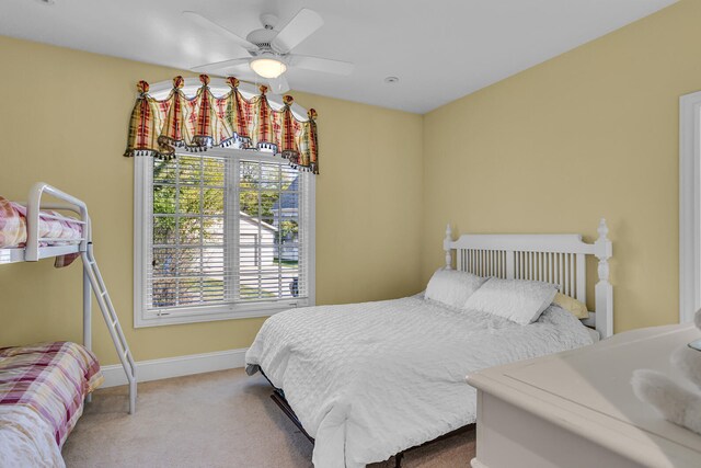 bedroom featuring ceiling fan, carpet flooring, and baseboards