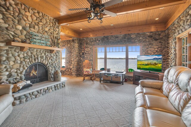 living room with beamed ceiling, wood ceiling, and a healthy amount of sunlight