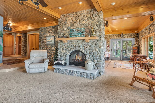 living room featuring wood ceiling, light carpet, and a stone fireplace