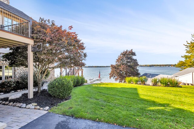 view of yard with a water view and a balcony