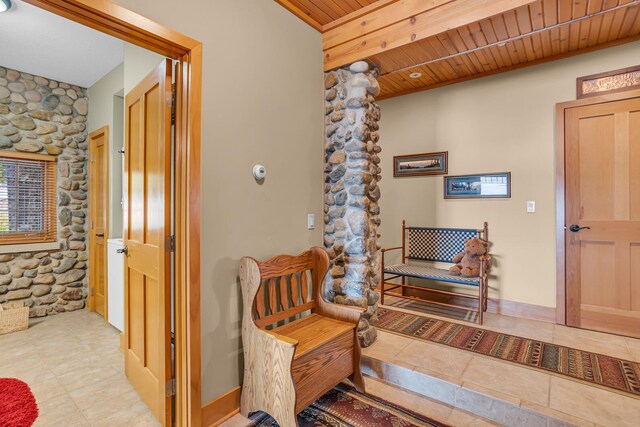 hallway featuring wooden ceiling and baseboards