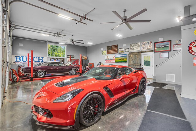 garage with baseboards, visible vents, and ceiling fan