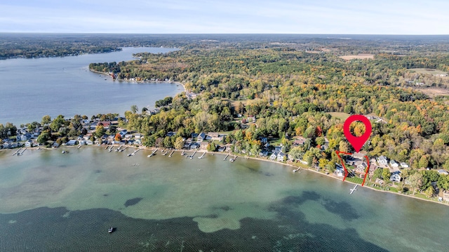 drone / aerial view featuring a water view and a view of trees