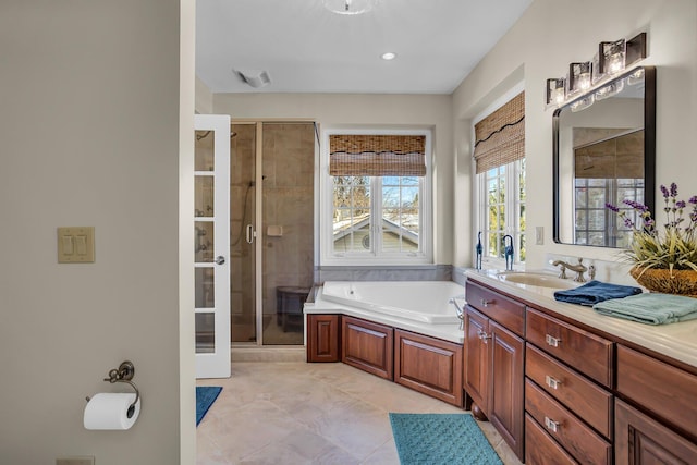 full bathroom featuring a shower stall, a bath, and vanity