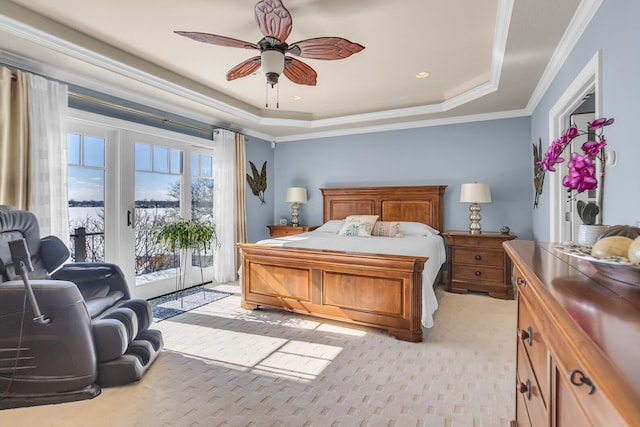 bedroom with ornamental molding, access to outside, light carpet, and a tray ceiling