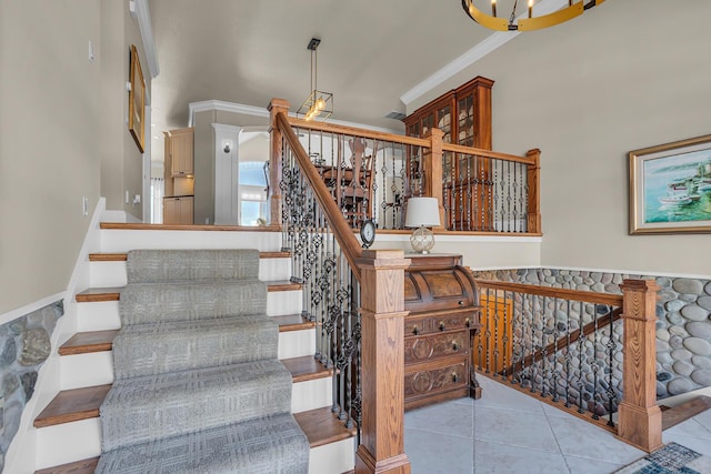 staircase with tile patterned flooring and crown molding