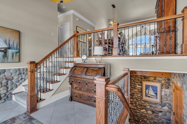 stairway with crown molding and tile patterned floors