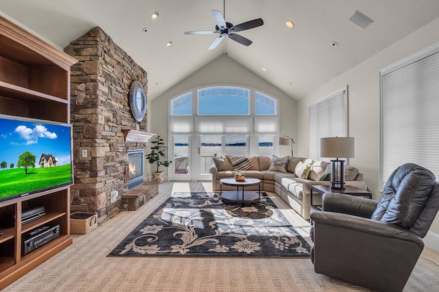 living room with visible vents, a fireplace, high vaulted ceiling, and a ceiling fan