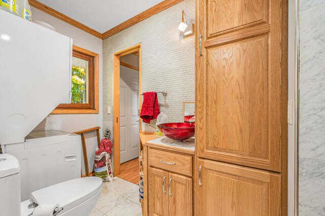 21598 Sylvan Rd, Reed City, MI 49677 - bathroom featuring toilet, crown molding, marble finish floors, and vanity