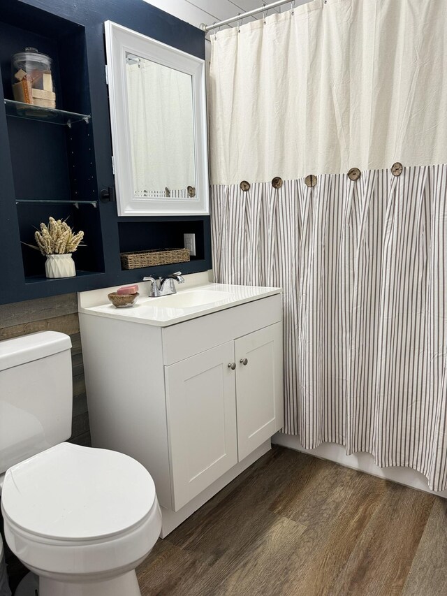 13067 Red Arrow Hwy, Sawyer, MI 49125 - bathroom with wood finished floors, vanity, toilet, and curtained shower