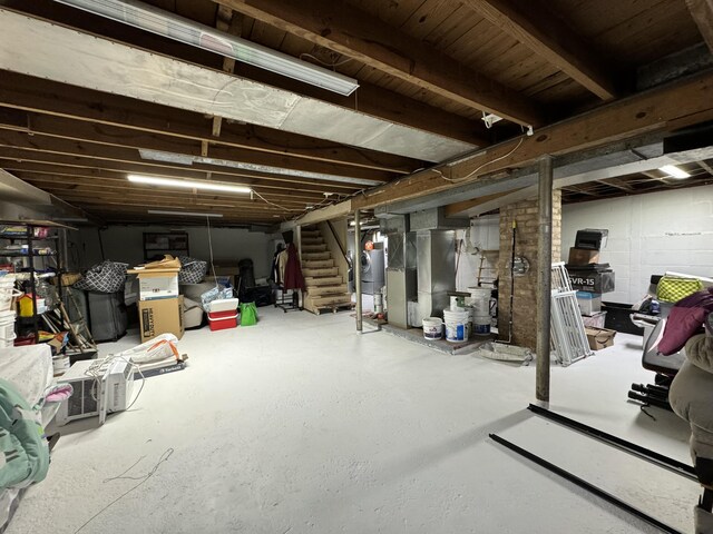 13067 Red Arrow Hwy, Sawyer, MI 49125 - unfinished below grade area featuring stairs, heating unit, and water heater