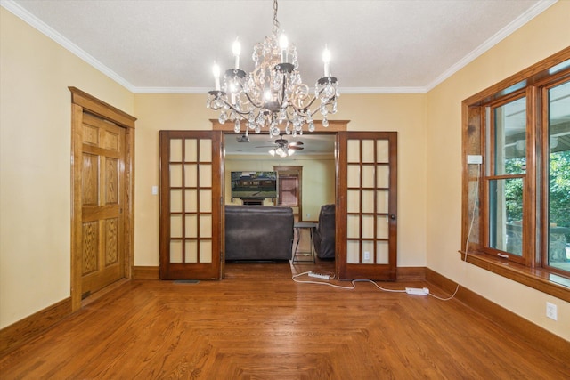 unfurnished dining area featuring ceiling fan with notable chandelier, ornamental molding, parquet flooring, and french doors