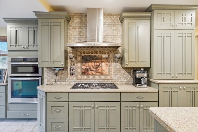 kitchen with wall chimney exhaust hood, light tile patterned floors, backsplash, and appliances with stainless steel finishes