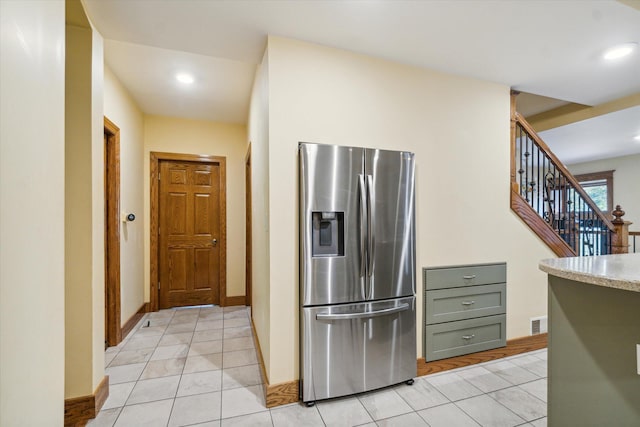 kitchen featuring stainless steel refrigerator with ice dispenser and light tile patterned floors