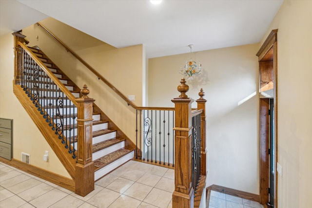 staircase featuring tile patterned flooring