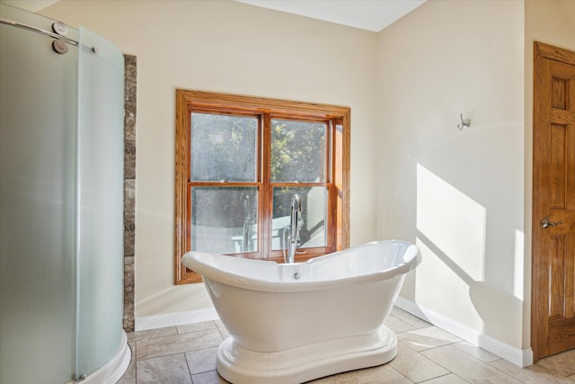 bathroom with separate shower and tub and tile patterned floors