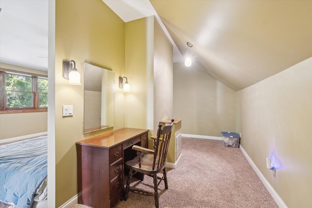 carpeted office with lofted ceiling