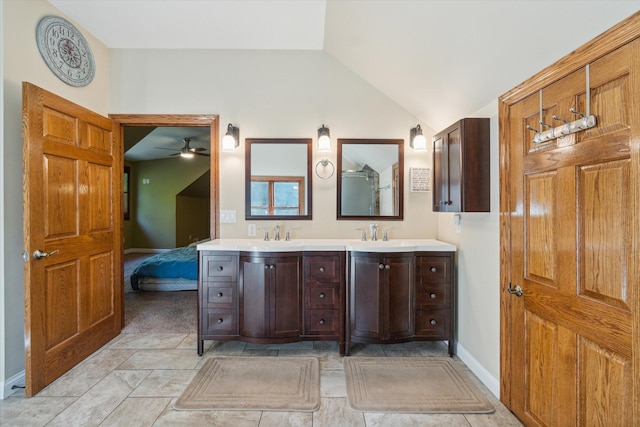 bathroom featuring ceiling fan, tile patterned flooring, vanity, and vaulted ceiling